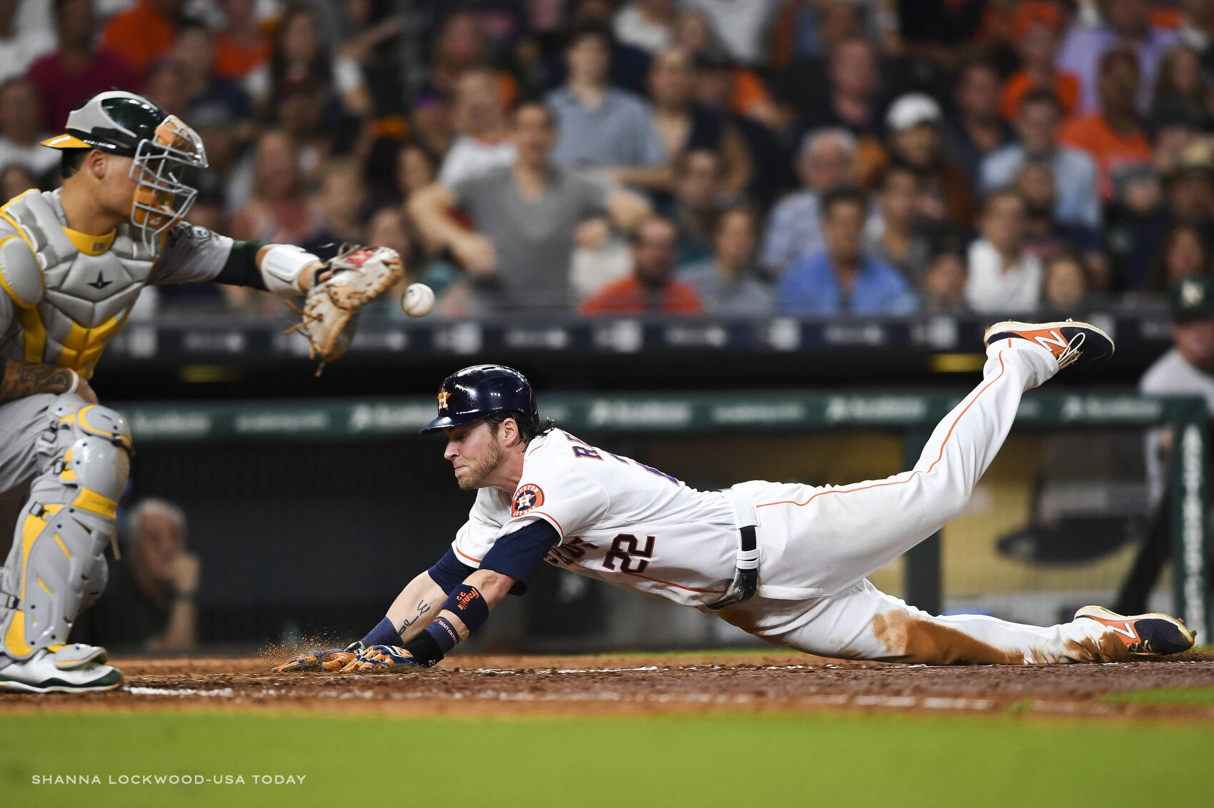  Jun 28, 2017; Houston, TX, USA; Houston Astros right fielder Josh Reddick (22) slides into home plate ahead of the tag by Oakland Athletics catcher Bruce Maxwell (13) during the sixth inning at Minute Maid Park. Mandatory Credit: Shanna Lockwood-USA