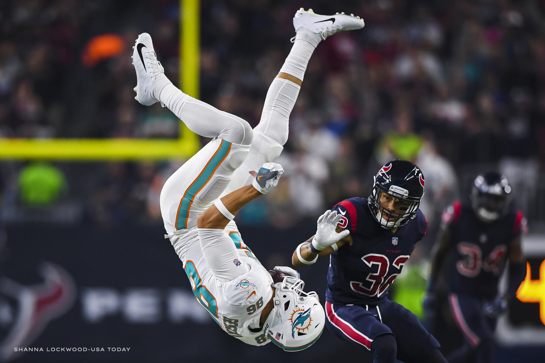  Oct 25, 2018; Houston, TX, USA; Miami Dolphins tight end Mike Gesicki (86) goes airborne after a tackle by Houston Texans strong safety Kareem Jackson (25, not pictured) during the second quarter at NRG Stadium. Mandatory Credit: Shanna Lockwood-USA