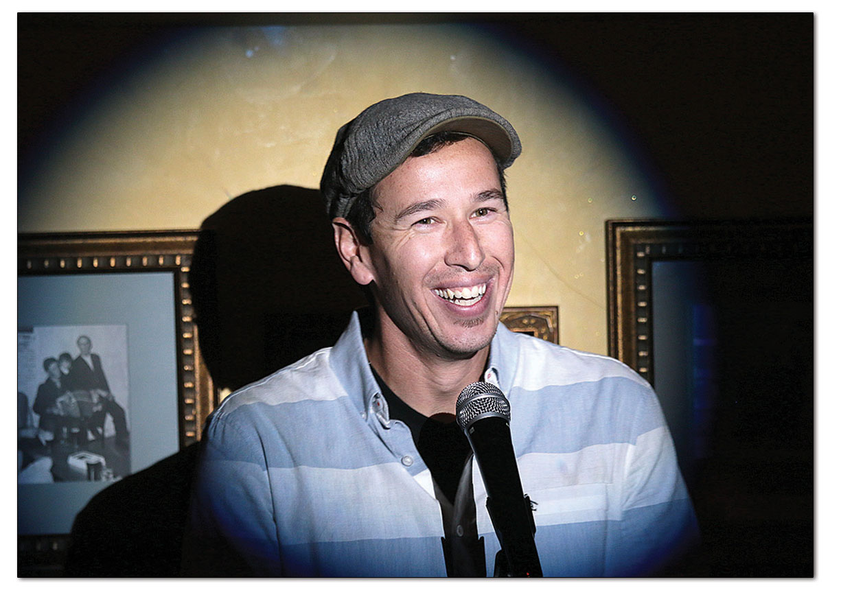 ‘Laugh Therapy’ founder Dan Korman takes to the mic at the Irish Embassy. A real estate broker by day, Korman started the open mic nights to allow himself and others to keep skills fresh or try their hand at stand up./Photo by Jennaye Derge
