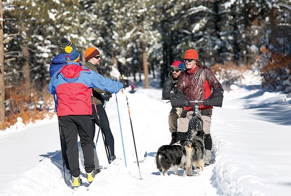 Trail users stop to chat at Boggy Draw on Fri., Jan. 27. The popular mountain biking area just outside Dolores is now being groomed by a dedicated crew of volunteers for winter use. There are 17.5 miles of track for cross country skiing, snowshoeing and fat biking./Photo by Jennaye Derge