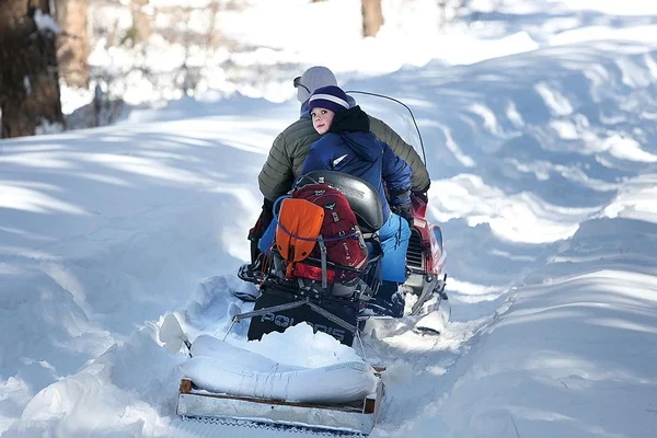 Boggy Draw volunteer Eric Houge and son, Grayson, 12, get the sandbags and snowmo out for some do-it-yourself grooming. The groomers are hosting a party/fund-raiser Feb. 12 in the Boggy Draw parking lot./Photo by Jennaye Derge