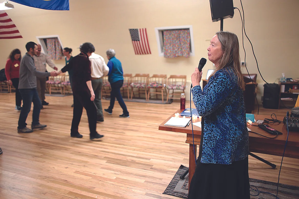 Carla Roberts calls out moves during a recent square-dancing event. Inspired by an- other female caller she met some years ago, she has been calling the Wild West Squares for four years./Photo by Jennaye Derge