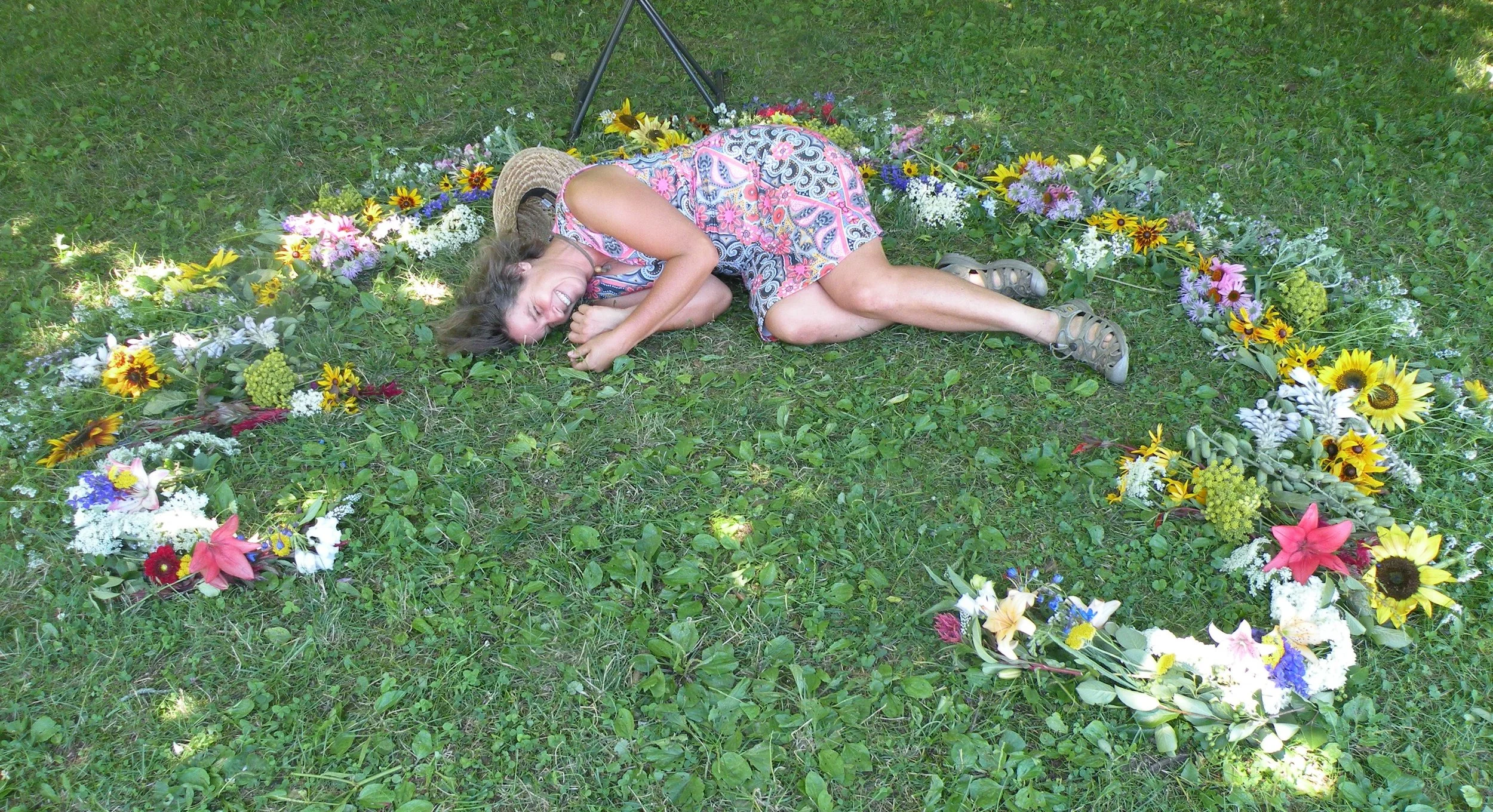 Laying down in a flower mandala at the end of a long design day. Photo by Rob McClure