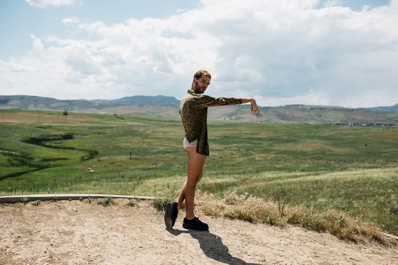 Are we human or are we dancers? A dancer stands before a wide open field and the Colorado foothills. Photography by Sonja Salzburg of Sonja K Photography.