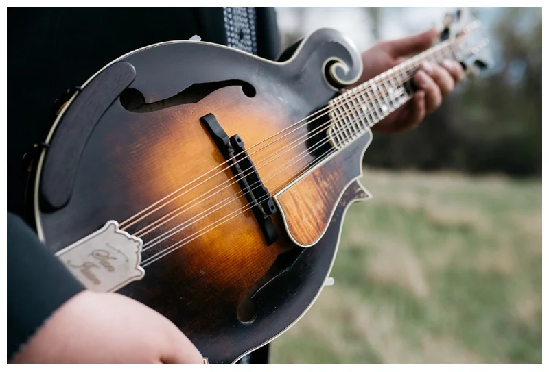 Eli Slocumb's mandolin in Lee Martinez Park in Fort Collins, Colorado. Portrait photography by Sonja Salzburg of Sonja K Photography.&nbsp;