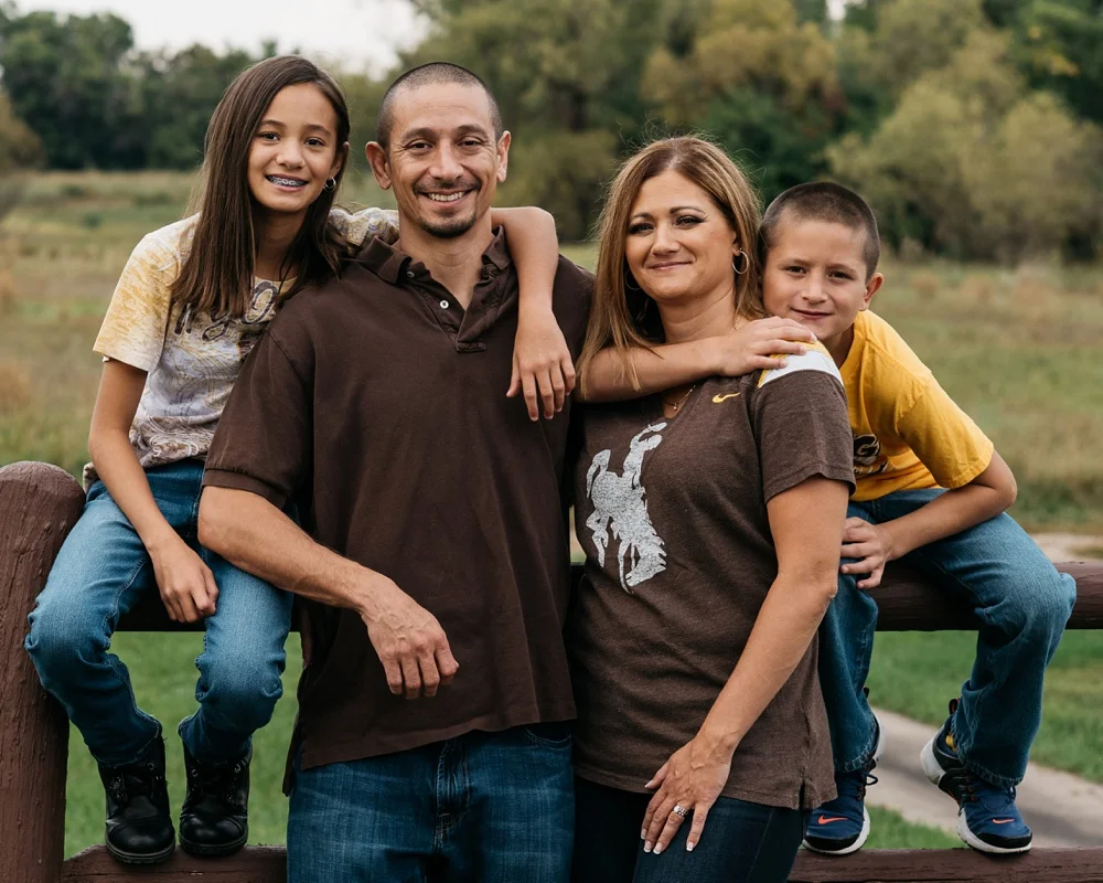 A beautiful young family at Lee Martinez Park in Fort Collins, Colorado. Family holiday portrait photography by Sonja Salzburg of Sonja K Photography.&nbsp;