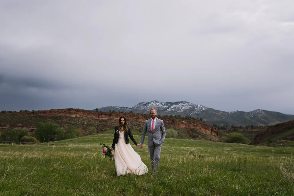 A bride and groom on a chilly fall day at Lory State Park outside of Fort Collins, Colorado. Wedding photography by Sonja Salzburg of Sonja K Photography.&nbsp;