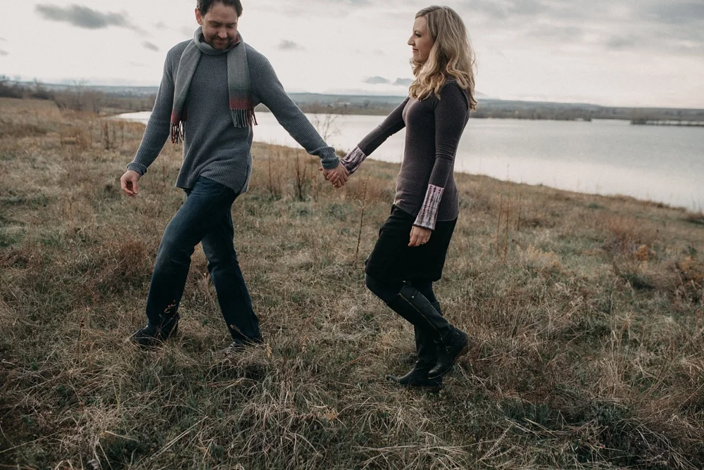 A couple is engaged at Standley Lake in Westminster, Colorado. Engagement and family portraits by Sonja Salzburg of Sonja K Photography.&nbsp;