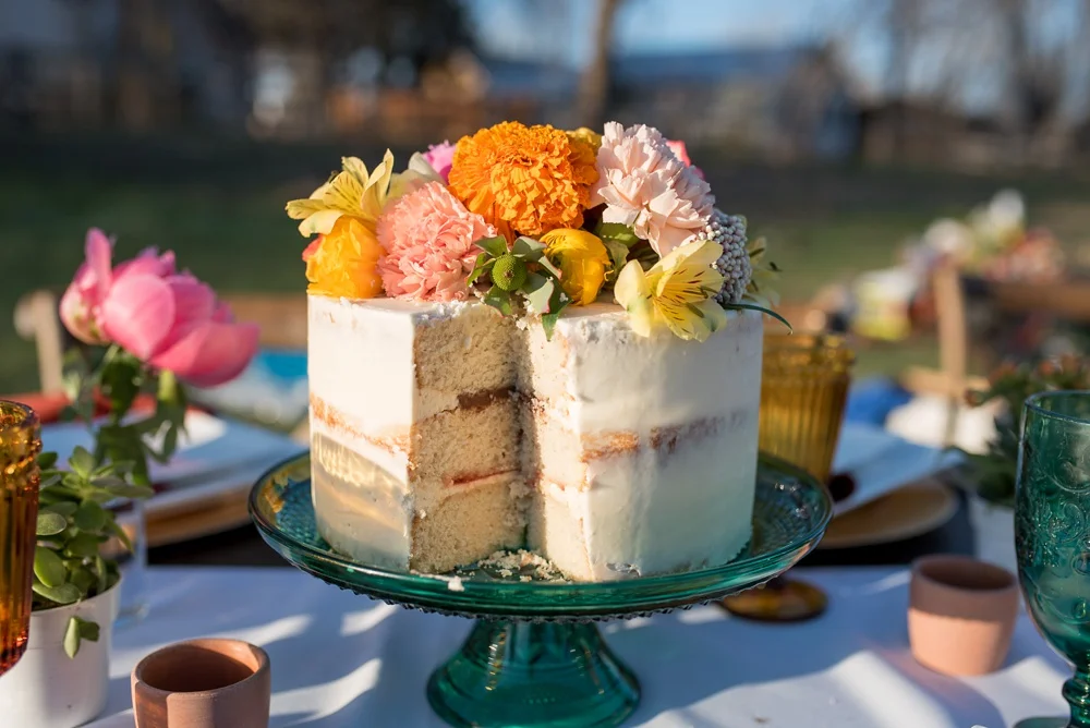 A cake by June Poppies on a table designed by Gumption and Grace at a styled shoot at Rist Canyon Inn outside of Laporte, Colorado. Wedding, styled shoot, and food and beverage photography by Sonja Salzburg of Sonja K Photography.&nbsp;