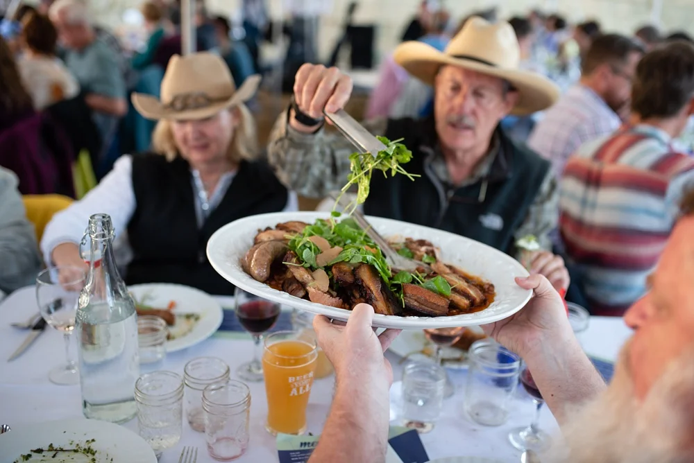 Guests enjoy dinner at the 2018 Fortified Collaborations Heart of Summer Farm Dinner at Colorado Stock and Grain Farm in Colorado. Food and Beverage and Event Photography by Sonja Salzburg of Sonja K Photography.