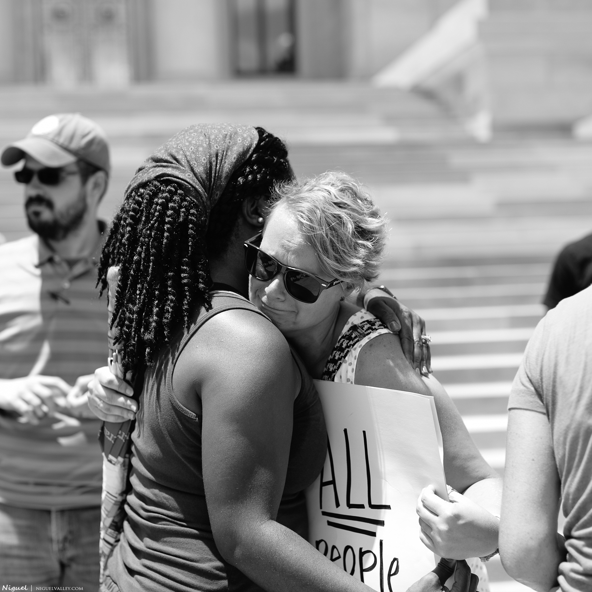 Kristen Valley (L) embracing Megan J. Pike (R), CBFAR Associate Coordinator, who needed to grieve over recent events at the Hands Up, Guns Down peaceful protest at the Arkansas State Capitol steps on Friday, 8 July 2016. photo taken by Niguel Valley