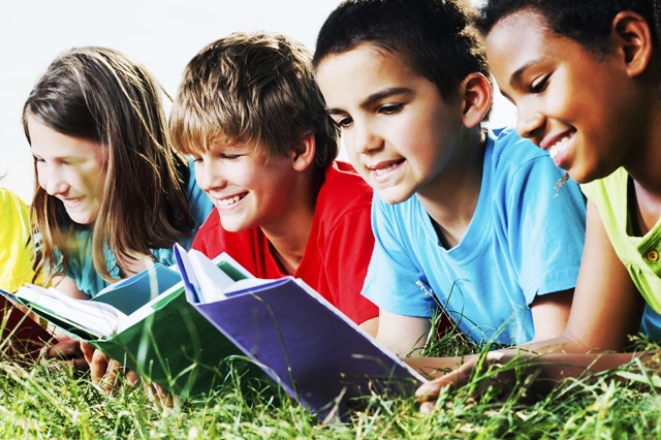 Young kids reading in grass.jpg