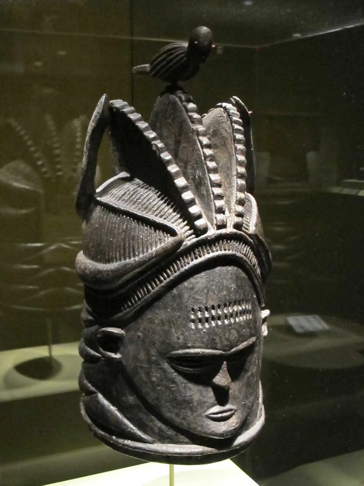 Helmet mask by Kaiwa, a Southern Bullom (Sherbro) artist, from Sierra Leone, of wood, pigment, abrus seeds, c. 1935.