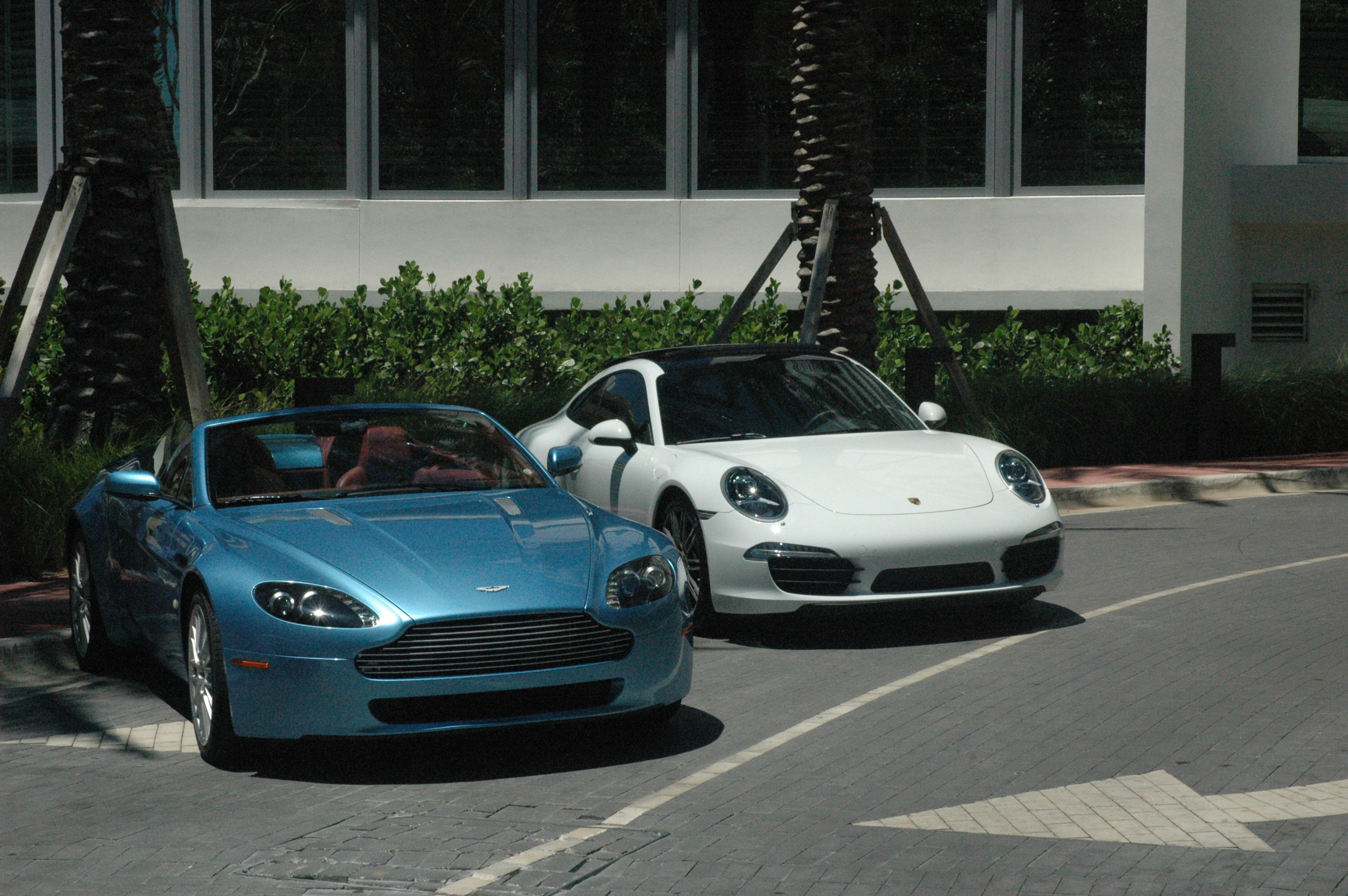 Aston Martin and a Porsche, outside a Miami Beach hotel.