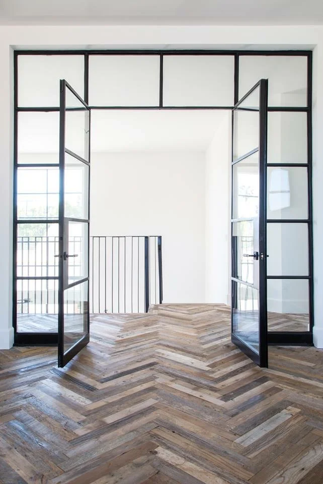 Steel doors and reclaimed wood chevron pattern.