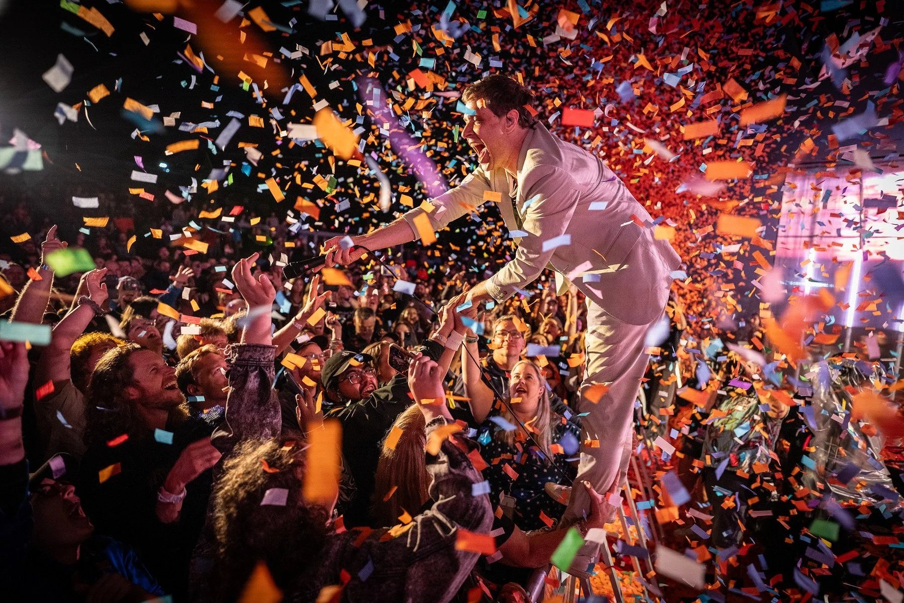 Damian Kulash of OK Go greets Denver fans in a blizzard of confetti.