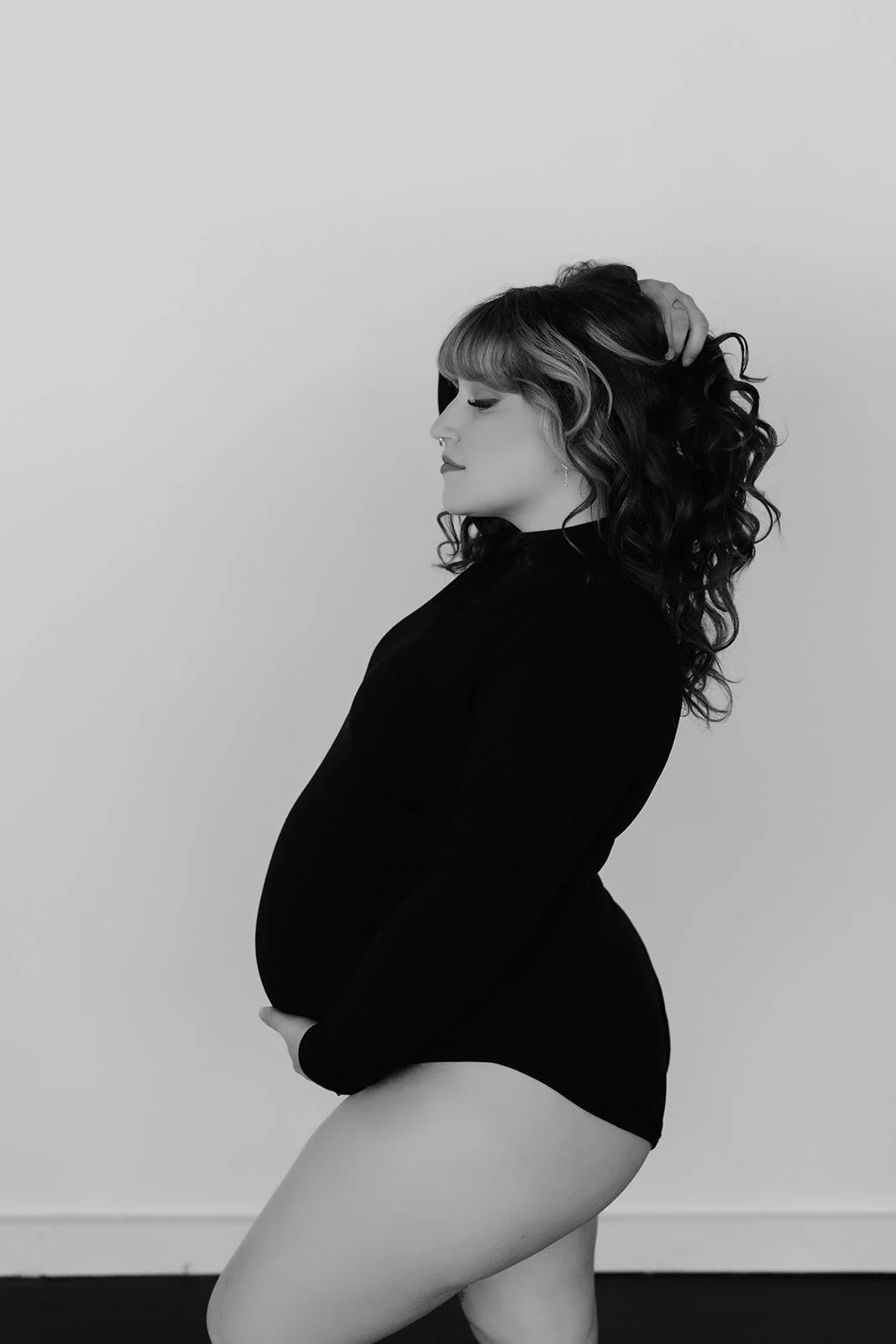 black and white maternity photographer in studio in rochester
