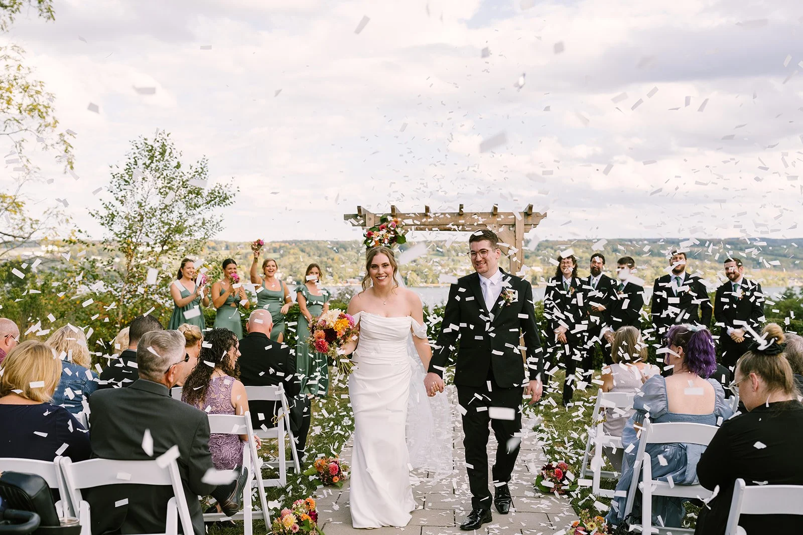 Couple celebrating walking back down the aisle with confetti at Crispin Hill