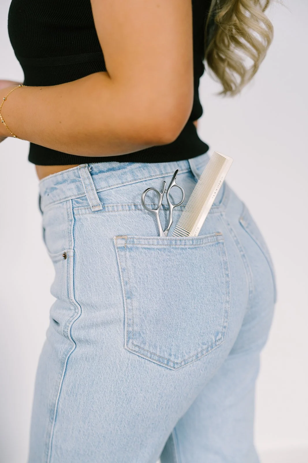 scissors and comb in back pocket for a hairstylist branding picture