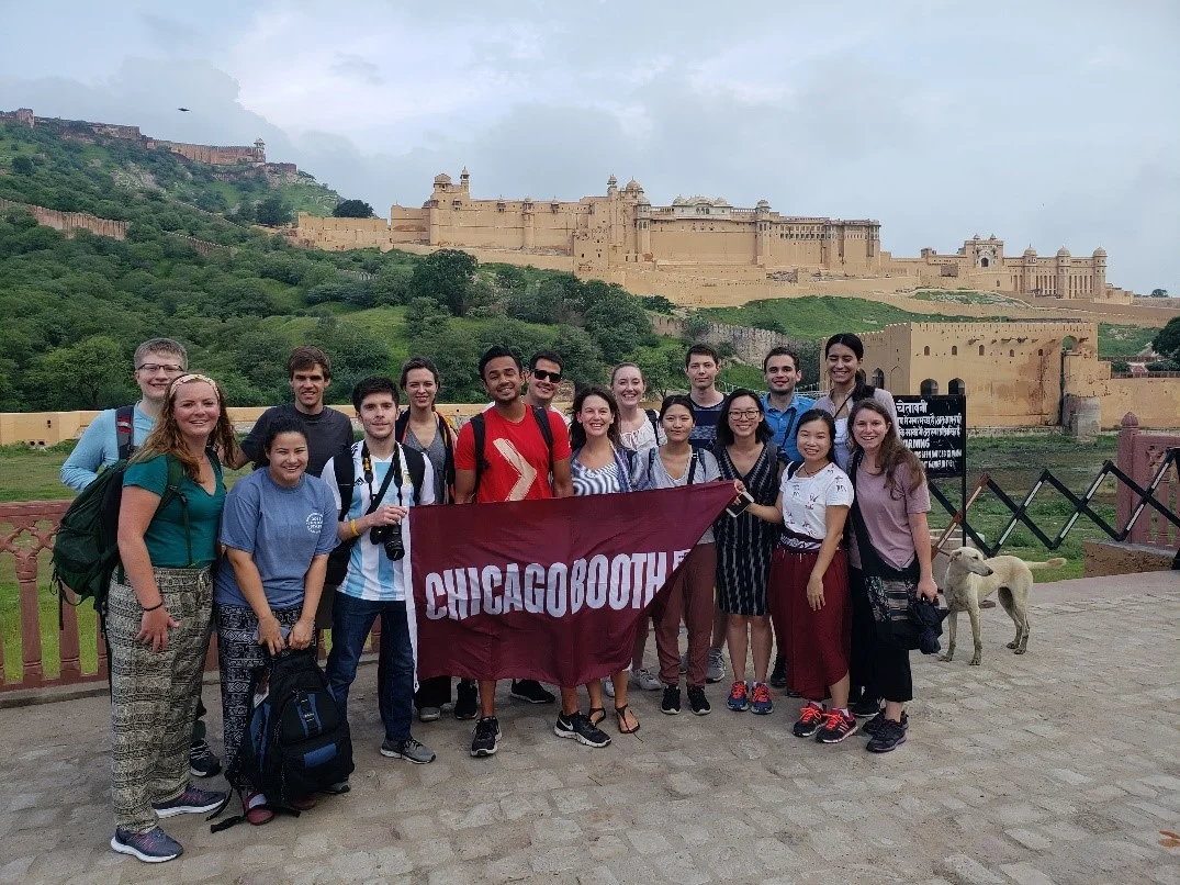 The group, photobombed by a dog in Jaipur, with Amer Fort looking on in the background.