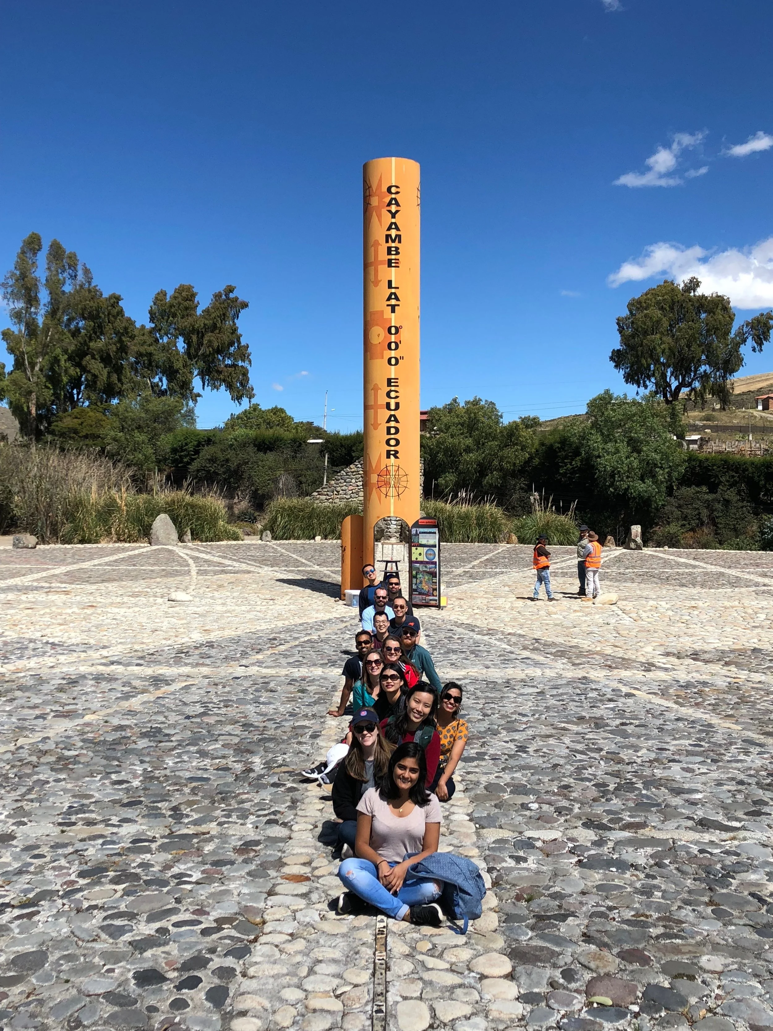 RW Ecuador gathers in front of the (fake) equator, but the adventures were all real: larva snacks and active volcanoes are no joke!