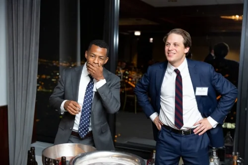 Elliot Thomas reacts to the grog with Ben Jacobson, both AFG members and Class of 2020