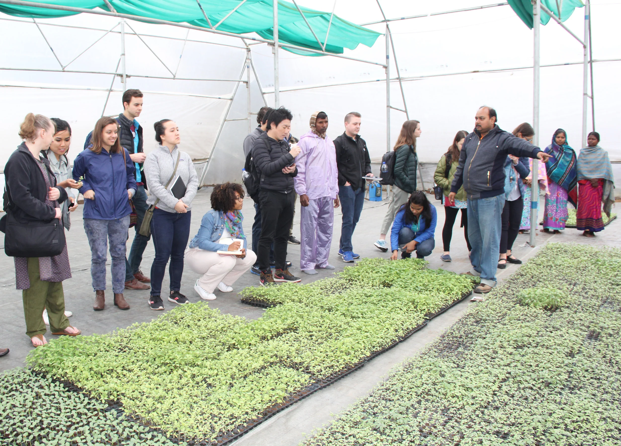 Booth students inspecting the soil-testing system in rural India as part of GSIP