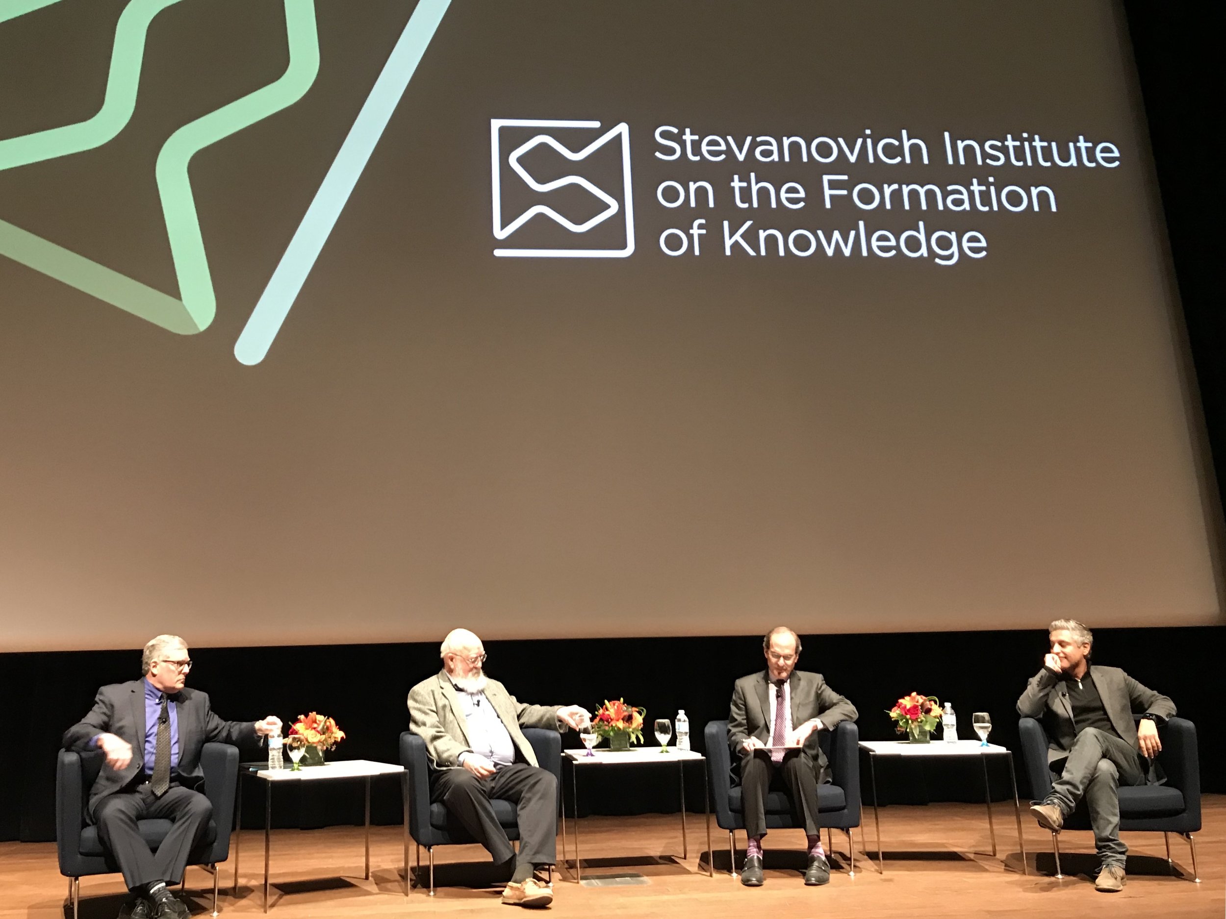 The panelists engage in a spirited discussion, moderated by Professor Nirenberg