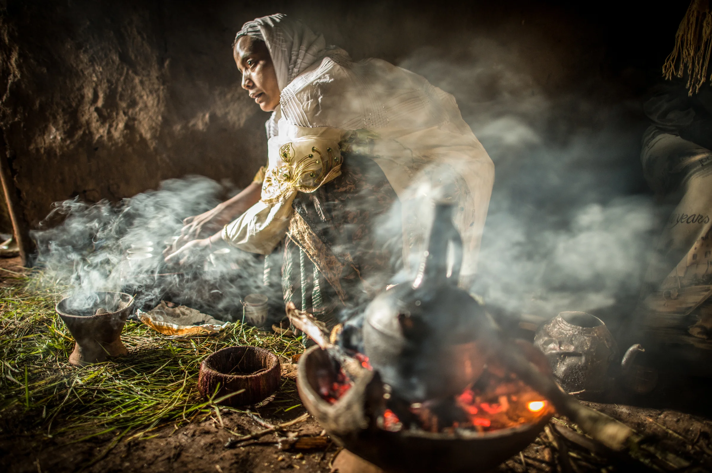Ramla Sharif roasts coffee inside her home in the village of Choche in Ethiopia. Legend has it this is the birthplace of coffee. The region is home to the largest pool of genetic diversity in the world of coffee. It is home to more genetic diversity in coffee than the rest of the producing countries combined by a huge margin. 2012 © Ami Vitale
