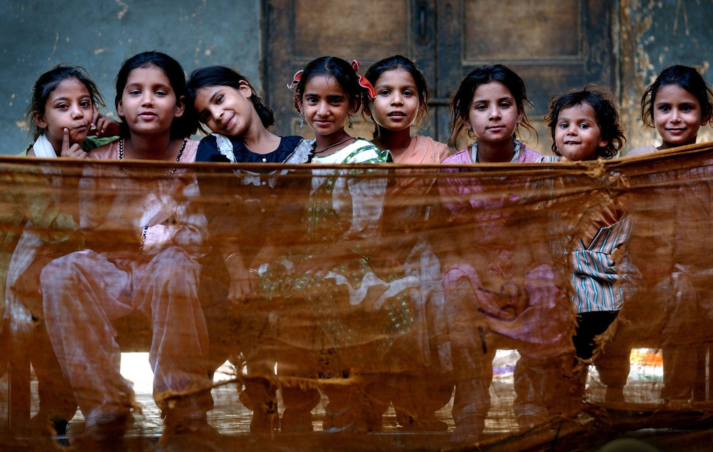 Muslim children sit inside Dariya Khan Ghhumnat Rahat refugee camp set up outside a school in the state of Gujarat in Ahmedabad, India. 2002 © Ami Vitale
