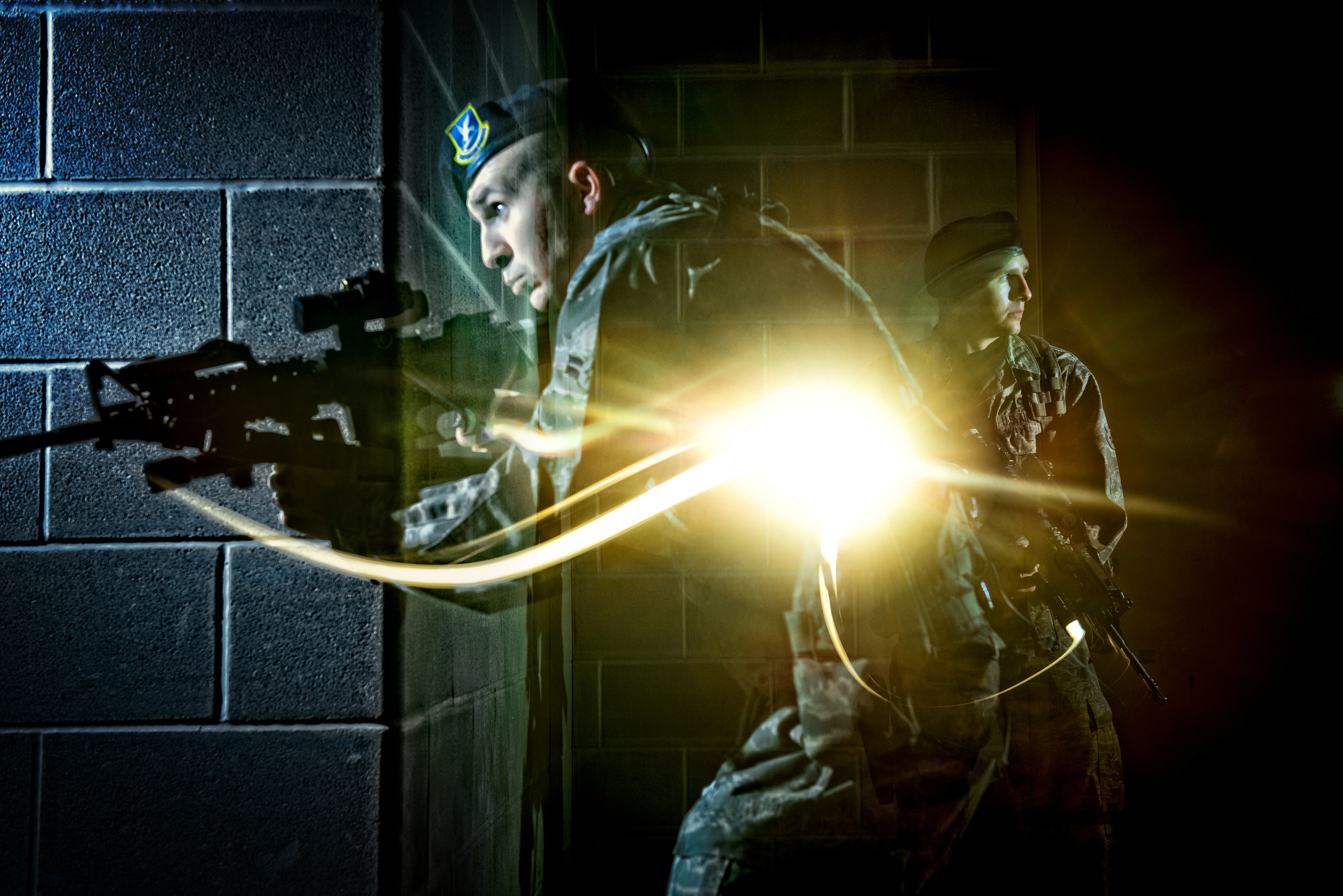 An Air Force Security Forces member tactically moves through the hallway of a dark building during clearing operations training in San Antonio, Texas. 2013 © Stacy L. Pearsall