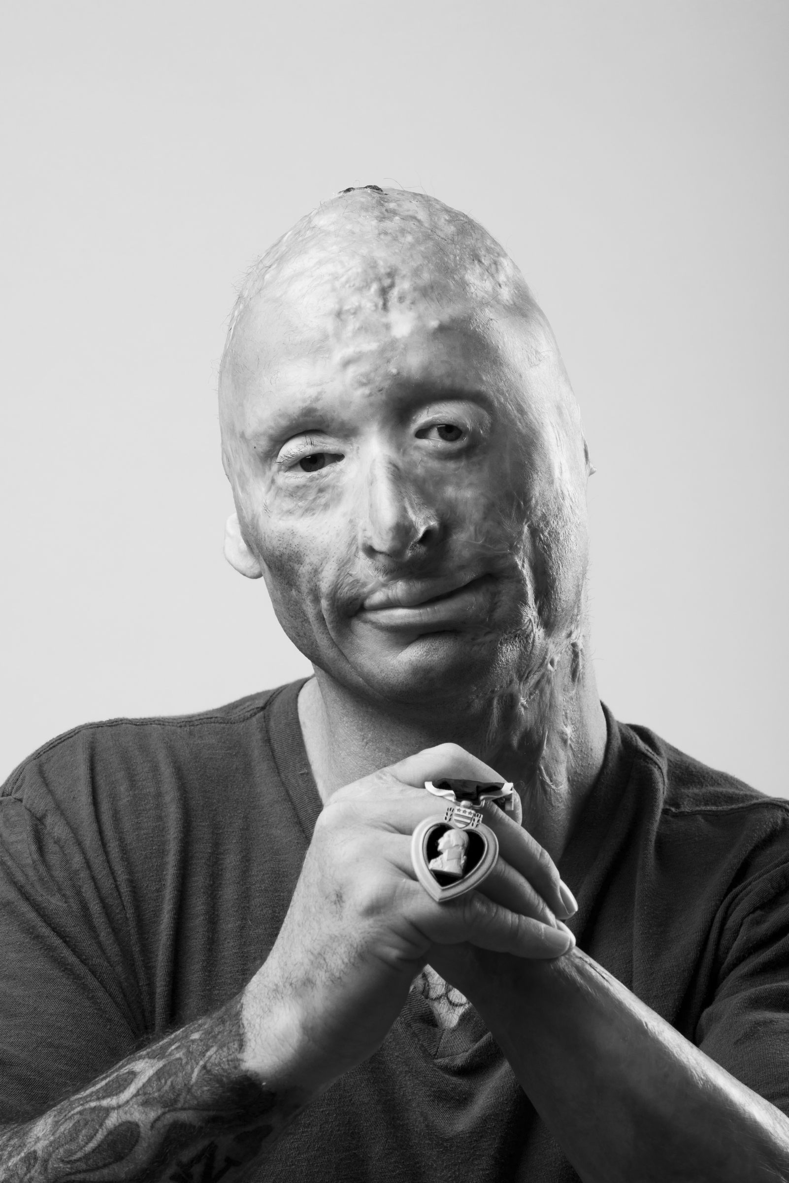 Robert “Bobby” Henline, also known as the “Burnt Comedian,” originally joined the Army in 1989. After his first enlistment he separated from service, only to be drawn back in October 2001. During the surge in Iraq, Staff Sergeant Henline deployed to Diyala Province as a transportation specialist. On April 7, 2007, an improvised explosive device struck Henline’s vehicle killing everyone but him. To best cope with the enormity of the situation, Henline turned to humor. He retired from the Army in January 2011 and is now a stand-up comedian. 2014 © Stacy L. Pearsall