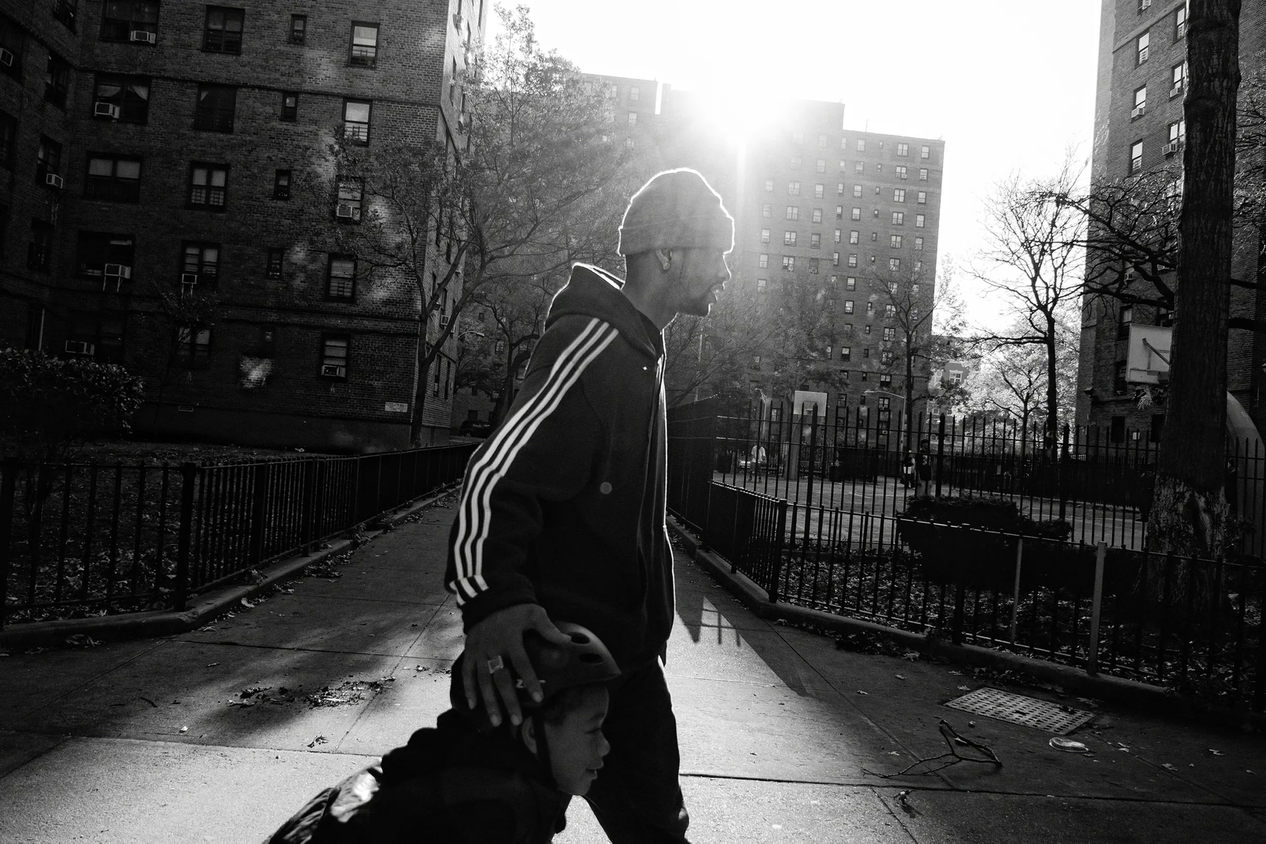 Jerell and Fidel Willis returning home from a day at East River Park. 2011 © Zun Lee