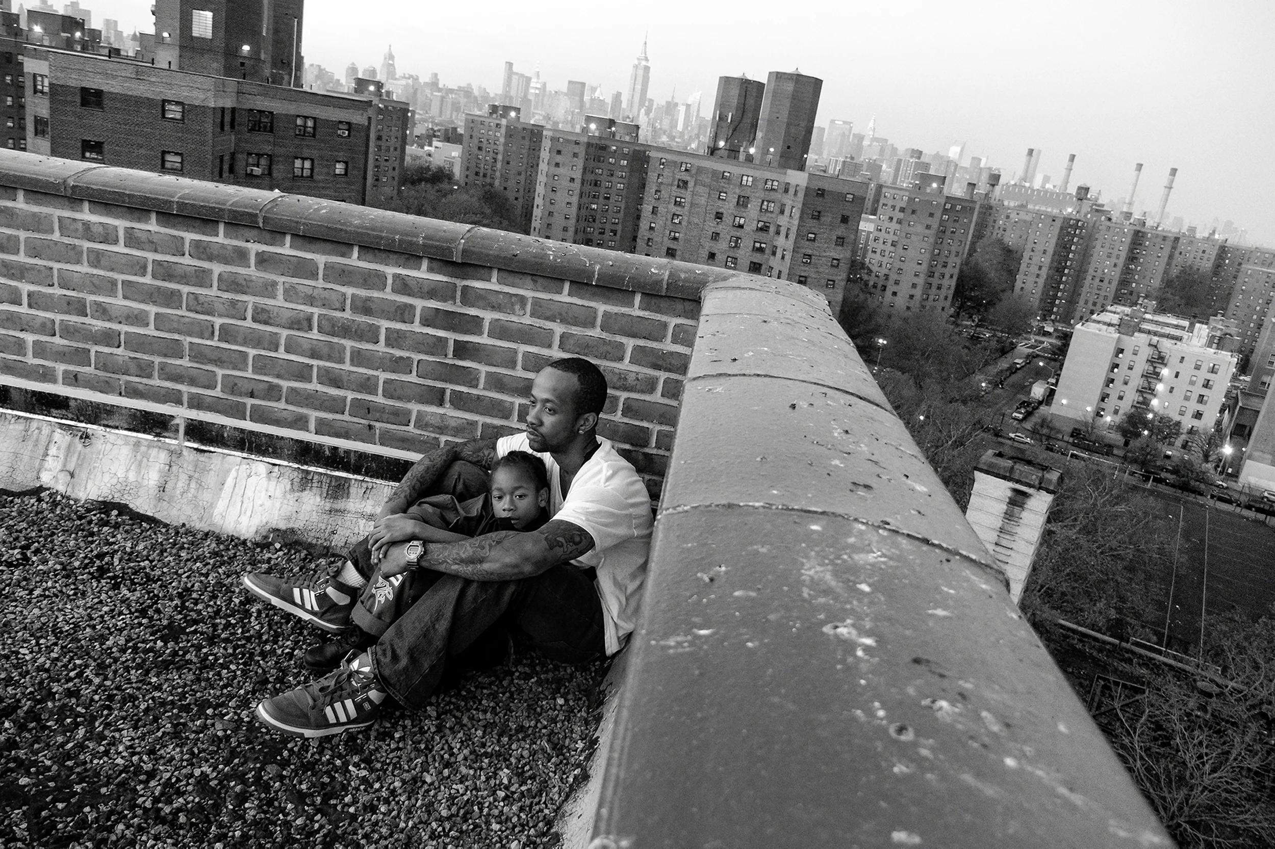 Jerell Willis and son Fidel on the rooftop of their apartment building, which often serves as a retreat from the city's hectic pace. 2011 © Zun Lee