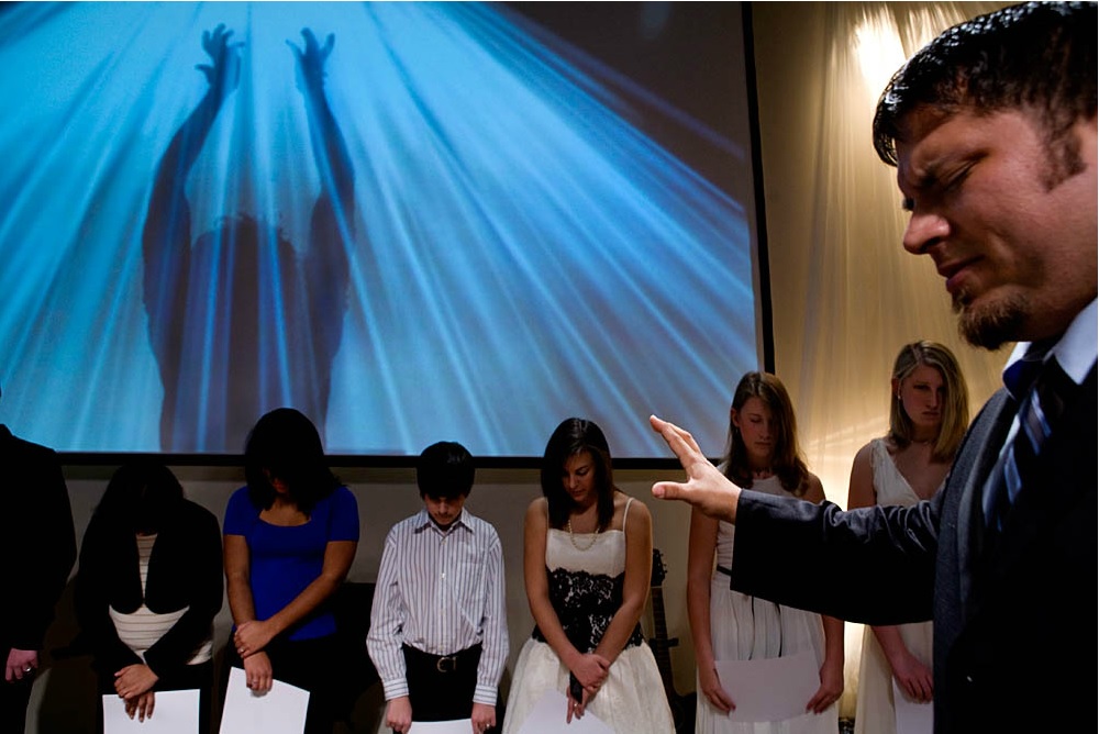   Virgins in America:  Associate Pastor J.R. Hall prays over the purity ring ceremony participants after they received their rings and "True Love Waits" commitment certificates at the Full Life Assembly of God in Franklin, TN. February 13, 2008 © Mar