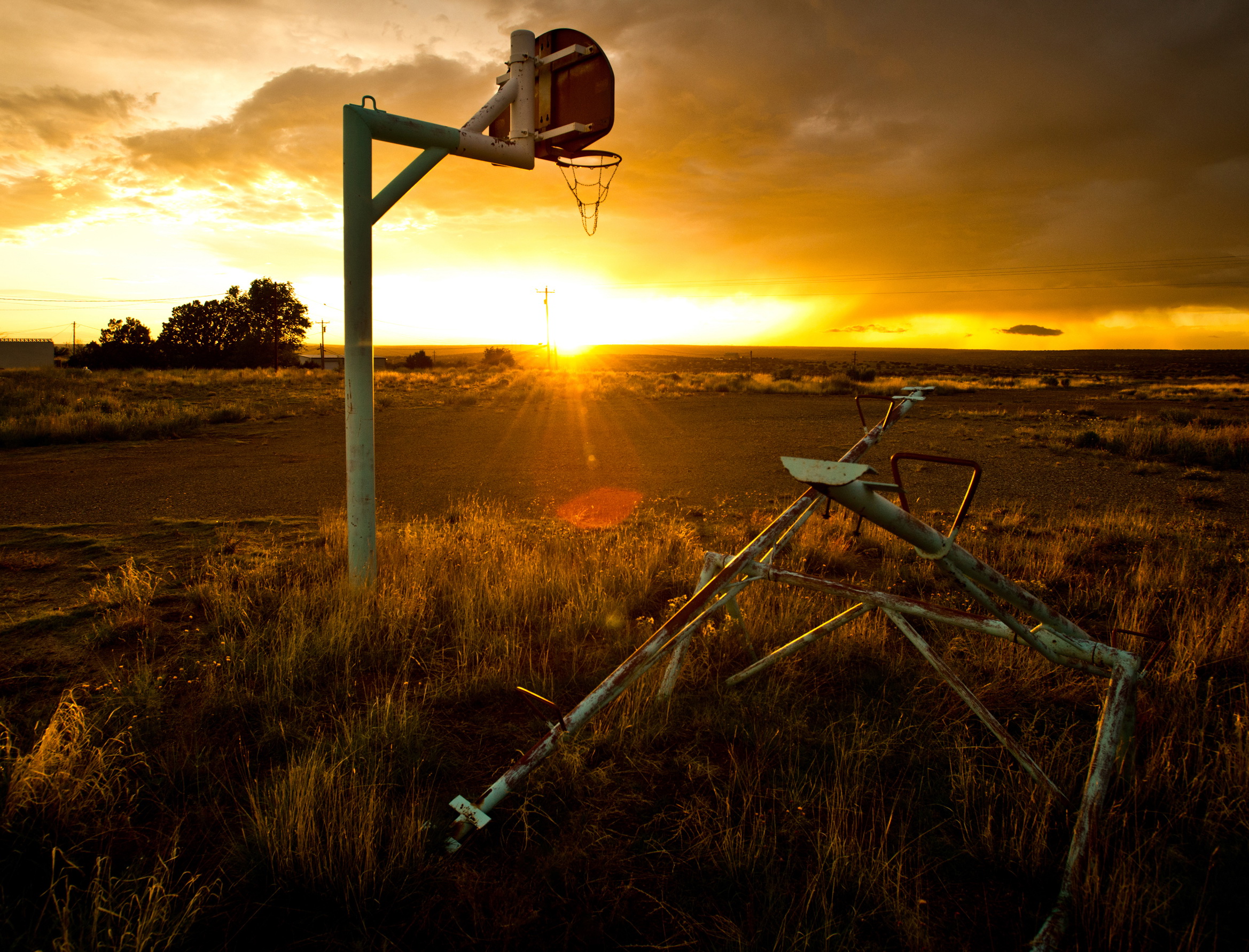 Sun sets on an old basketball hoop in New Mexico © Rob Hammer