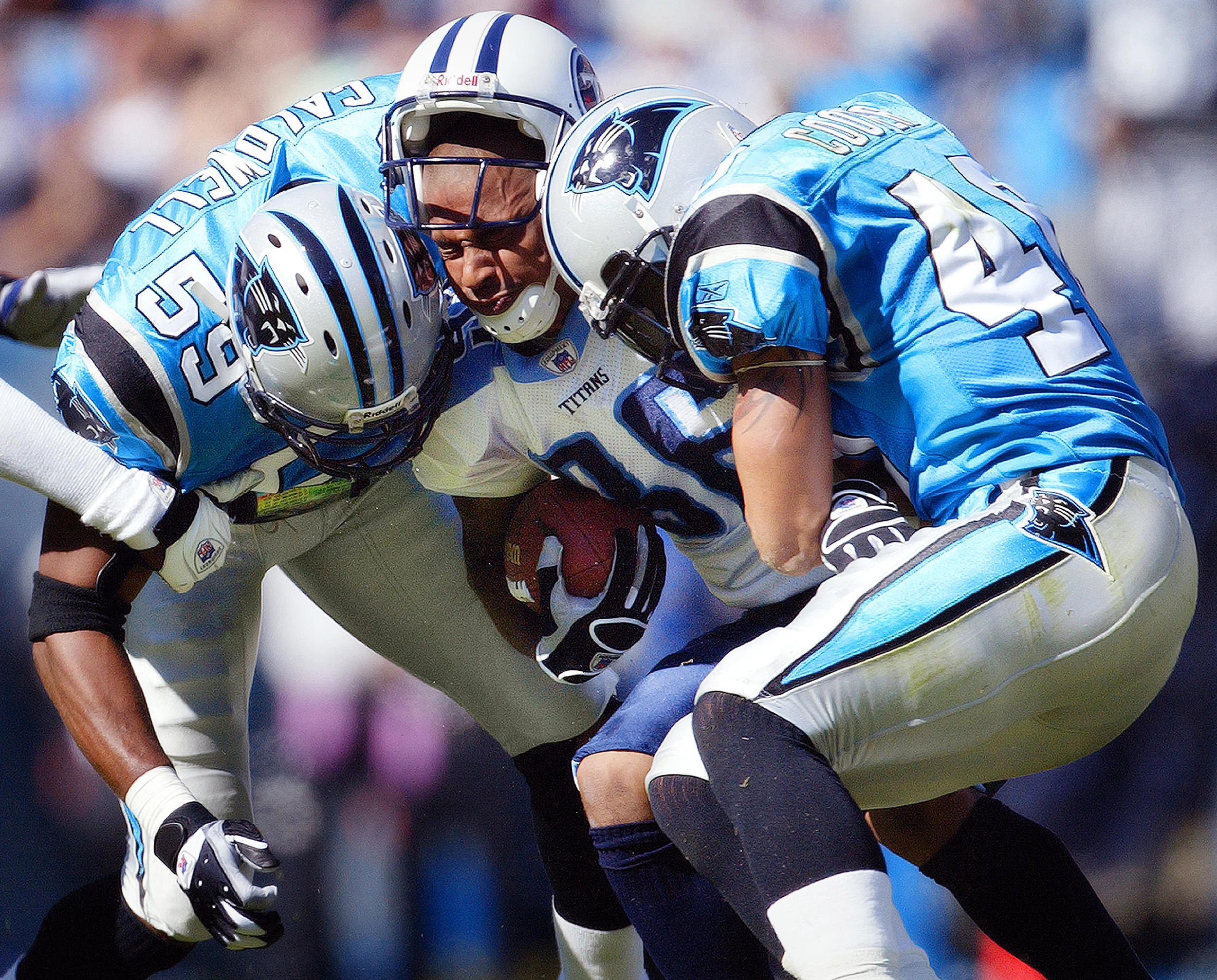Running back Eddie George of the Tennessee Titans gets sandwiched by two Carolina Panthers defenders. © Bill Frakes/Sports Illustrated