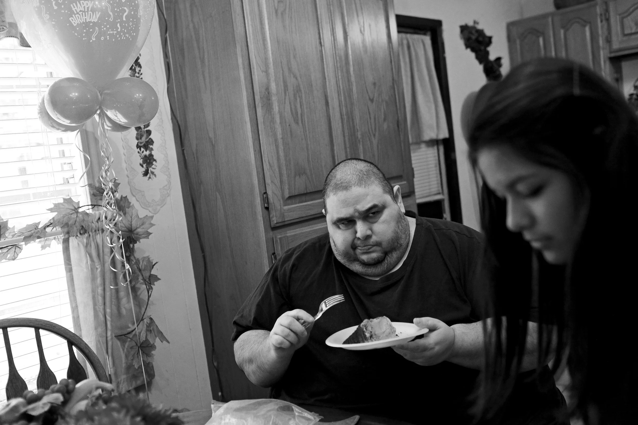 Hector Garcia Jr. is skeptical of the sugar-free cake his mother bought for him as he celebrates his 45th birthday with his niece, Lauren Ibarra. © Lisa Krantz/San Antonio Express-News/ZUMA Press