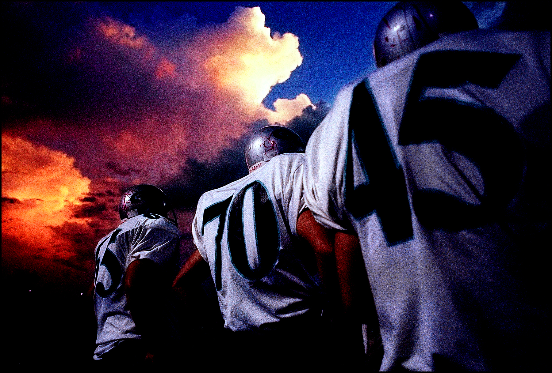 Gulf Coast High School football players await their turn on the sideline during a pre-season exhibition game with Sarasota-Booker High School. ©Lisa Krantz/Naples Daily News