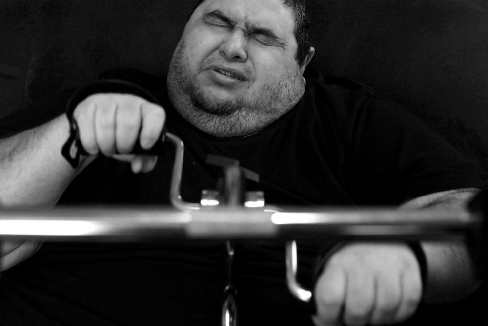   Hector Garcia Jr.&nbsp;uses a upper-body pedal exerciser at his home. Unable to leave the house or walk without the aid of a walker and wheelchair, Garcia had to figure out different ways to burn calories.&nbsp; © Lisa Krantz/San Antonio Express-Ne