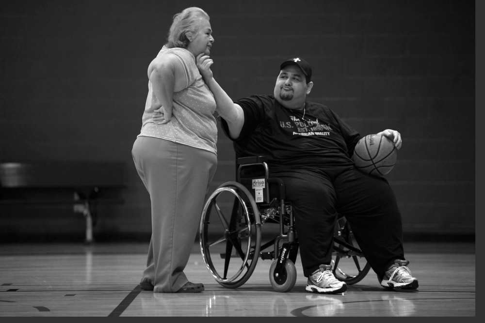   Hector Garcia Jr. teases his mother and caretaker, Elena Garcia, as he shoots baskets at the West-side Family YMCA. When Garcia began going to the YMCA, he was only able to walk in the pool. As he lost weight and became more mobile, he could eventu