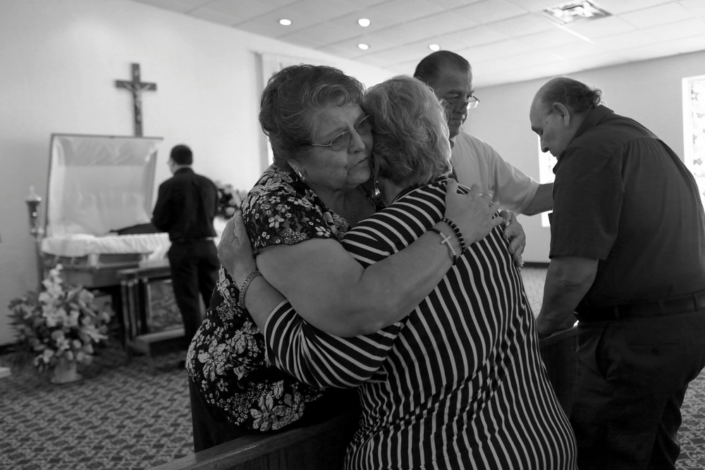   Elena Garcia and Hector Garcia Sr., the parents of Hector Garcia Jr., are embraced by their best friends, Patsy and Ruben Villarreal, during the private viewing for their son at Trevino Funeral Home Palo Alto.&nbsp; © Lisa Krantz/San Antonio Expres