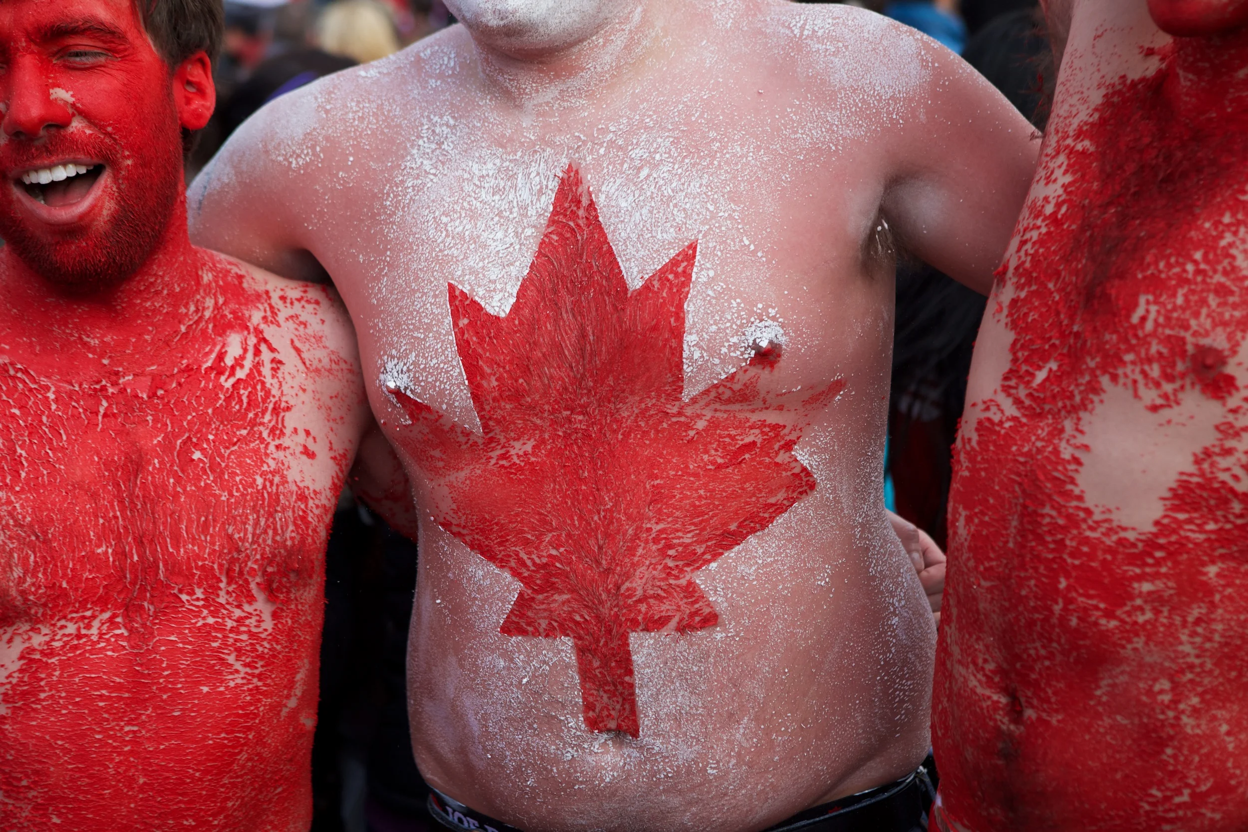 Fans celebrate Canada's Olympic gold medal men's hockey victory over the United States at Robson Squire in the streets of downtown Vancouver. © Sol Neelman