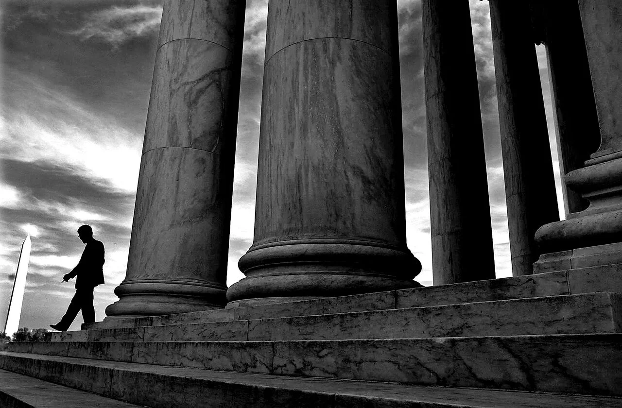 A lone visitor to the Jefferson Memorial, Kim Seung Hoon, walks down the edge of the marble steps facing the Tidal Basin. © Mary F. Calvert/ZUMAPRESS.com
