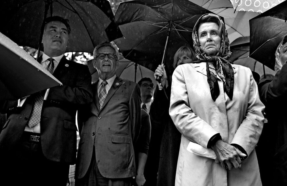   House Minority Leader Nancy Pelosi stands in the pouring rain after addressing the crowd at the "Stop the Lockout" rally at Upper Senate Park in Washington DC.  © Mary F. Calvert/ ZUMAPRESS.com       