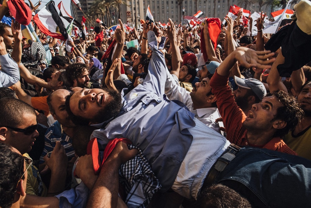   A supporter of the Muslim Brotherhood overcome by emotion is carried onto the stage as Egyptians celebrate the election of their new president Mohamed Morsi in Tahrir Square in Cairo, Egypt. June 24, 2012 &nbsp; © Daniel Berehulak/Getty Images  