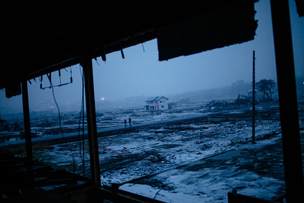   People walk down a stretch of road in a neighborhood ravaged by last year's tsunami in Ishinomaki, Japan. March 2, 2012 © Daniel Berehulak/Getty Images  