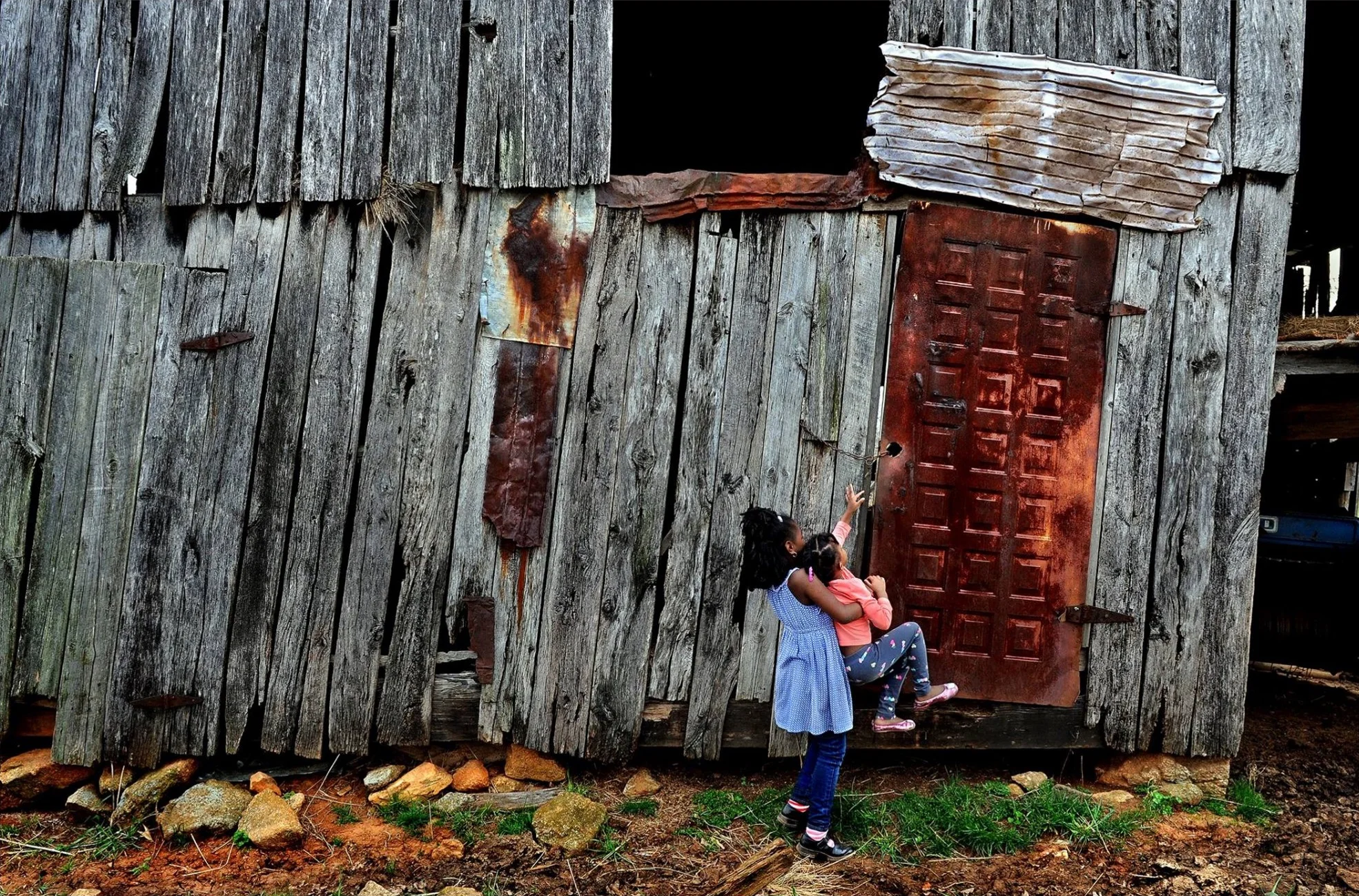 A curious Juliet Pace (age 4) and her cousin Campbell (age 7) got quite a history lesson on Monday as they visited a nearly forgotten slave cemetery where some of their relatives are buried. They also explored a restored slave shack on the grounds of Sweet Briar College (in Amherst, Va.) and this great old barn that belongs to their 75-year-old cousin Jasper. The farm has been in the family since just after the civil war. © 2015 Michael S. Williamson/The Washington Post