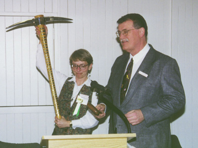 Past Presidents Carol Hasenberg and Ray Crowe make light with the GSOC pickaxe and gavel during the 2000 GSOC banquet.