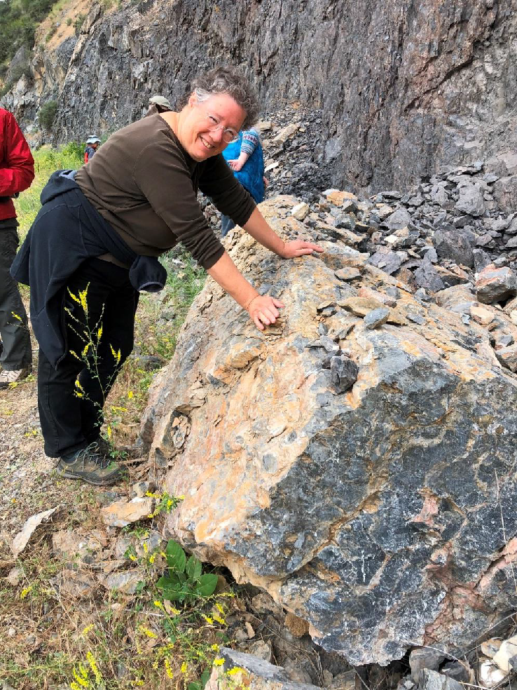 Carole Miles poses near a boulder from the Martin Bridge Formation on the last stop before leaving the canyon.